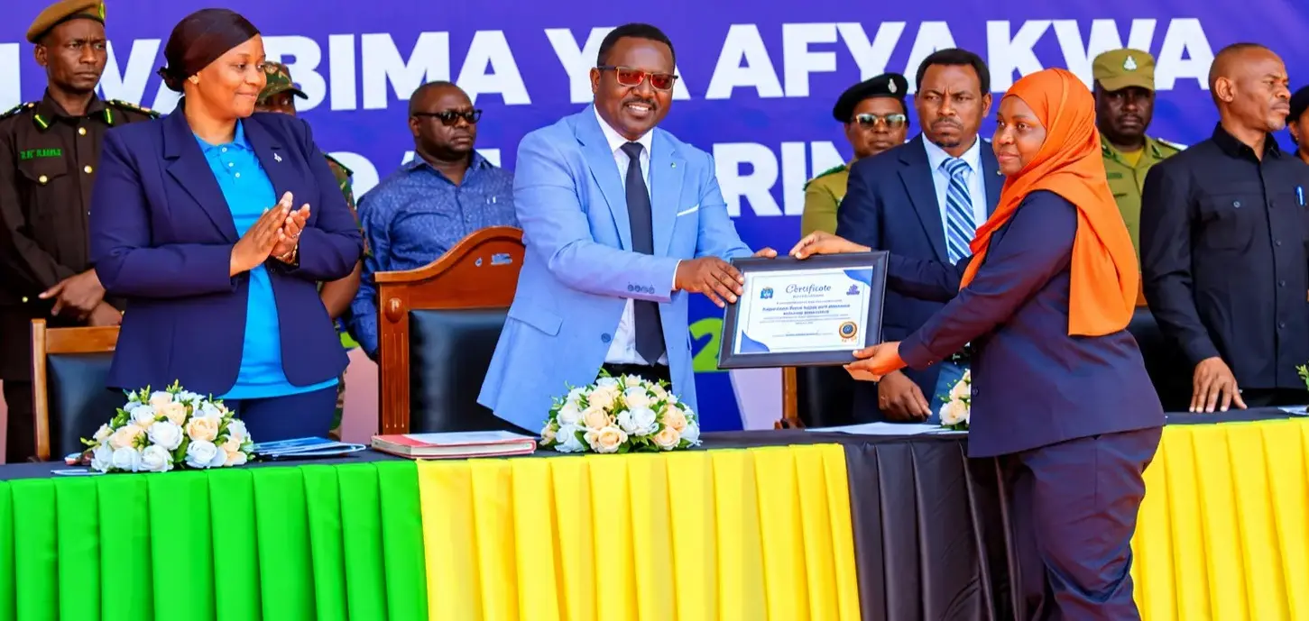 The IRUWASA Director of Human Resource and Administration (Amina Mwinyi) receiving a cerfificate of the First Runner-Up for the Outstanding Performance in Employee Enrollment for Universal Heath Coverage from National Heath Insurance Fund (NHIF)
