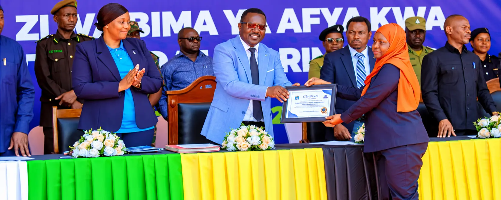 The IRUWASA Director of Human Resource and Administration (Amina Mwinyi) receiving a cerfificate of the First Runner-Up for the Outstanding Performance in Employee Enrollment for Universal Heath Coverage from National Heath Insurance Fund (NHIF)